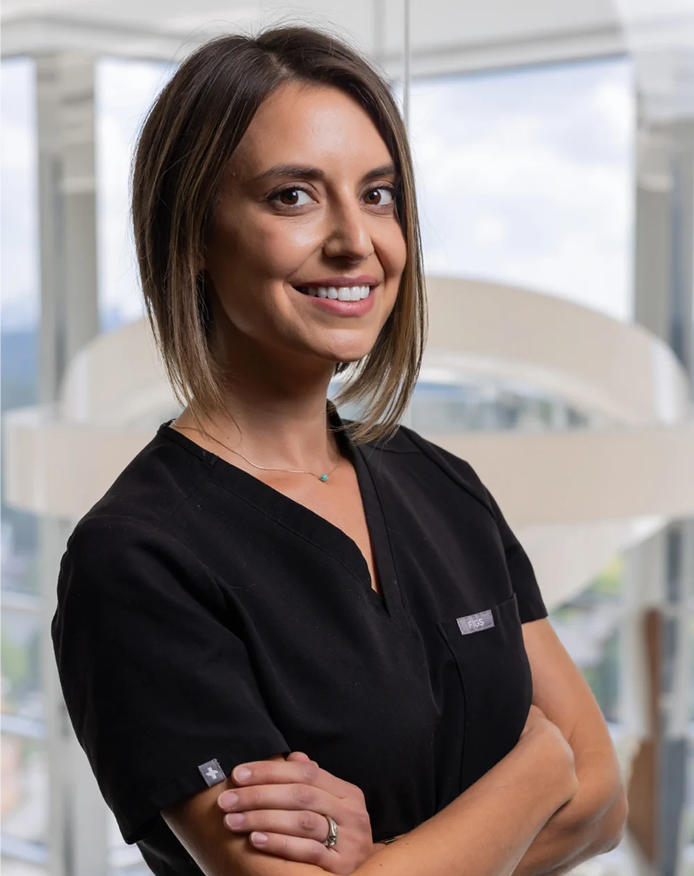 Dentist Decatur GA Dahlia Levine HP About A professional photo of Dahlia Levine from Decatur Family Dental crossing her arms